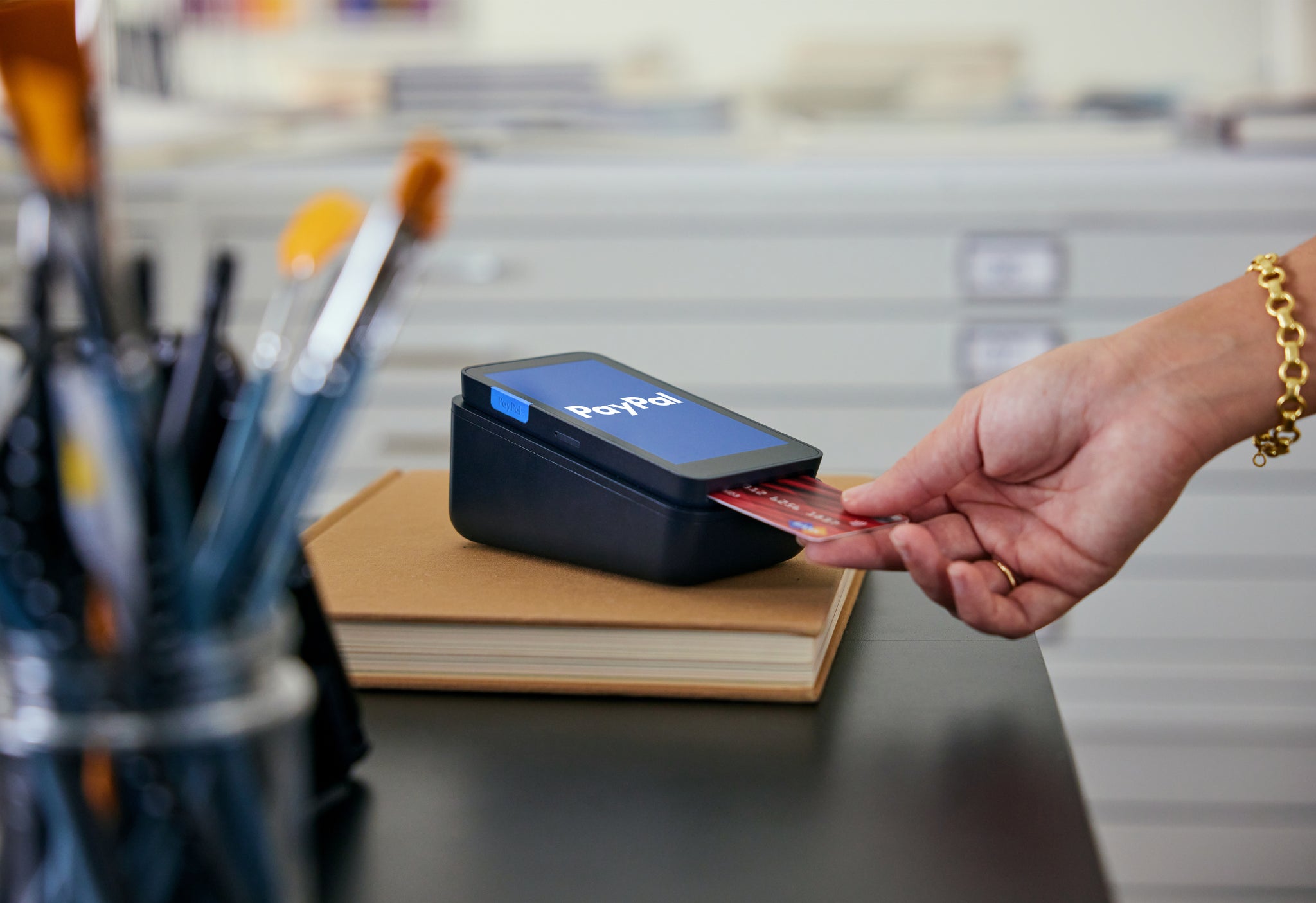 A customer inserting their chip card into a PayPal Terminal